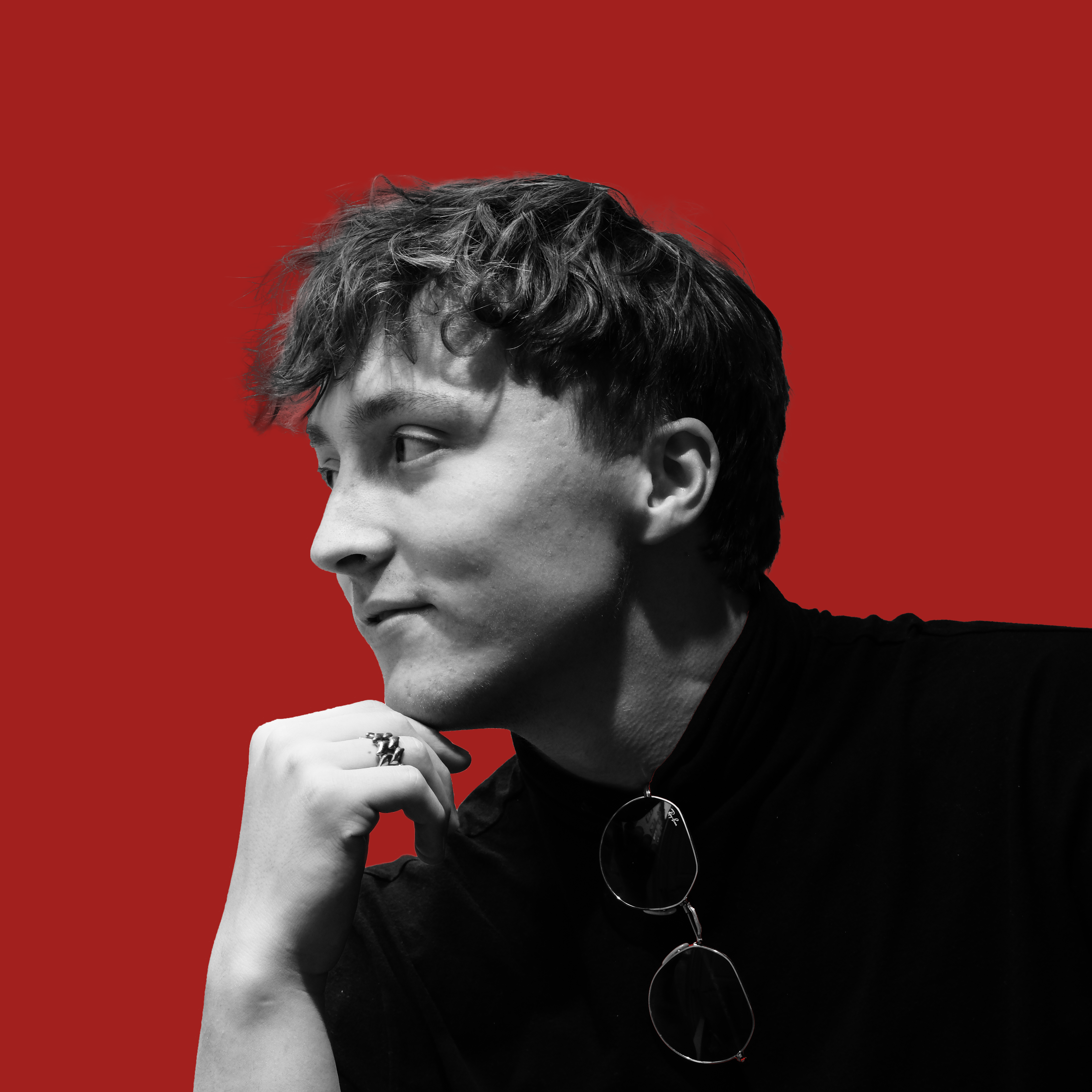 Portrait of Dominik Procházka against a red background